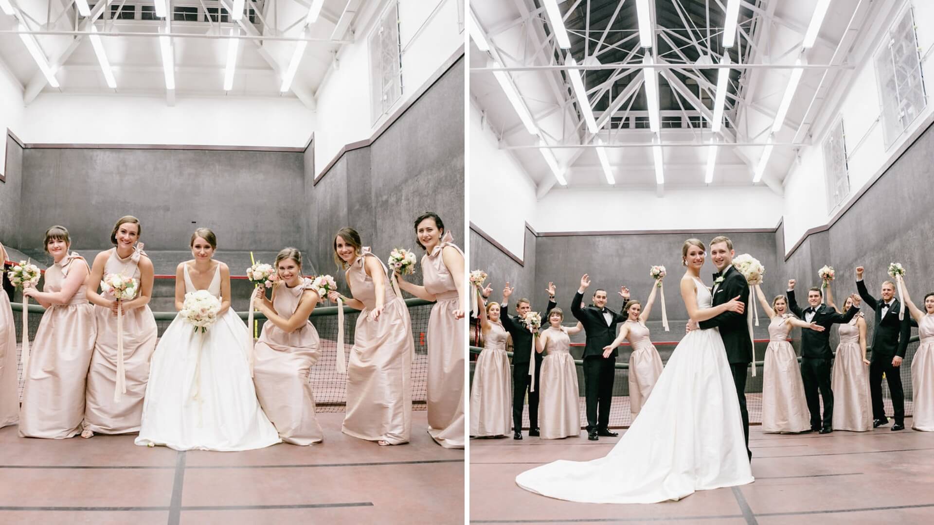 Bridal party posing on an indoor tennis court; bridesmaids in pink dresses, groomsmen in black suits, and the bride and groom in formal attire, all smiling and holding bouquets.