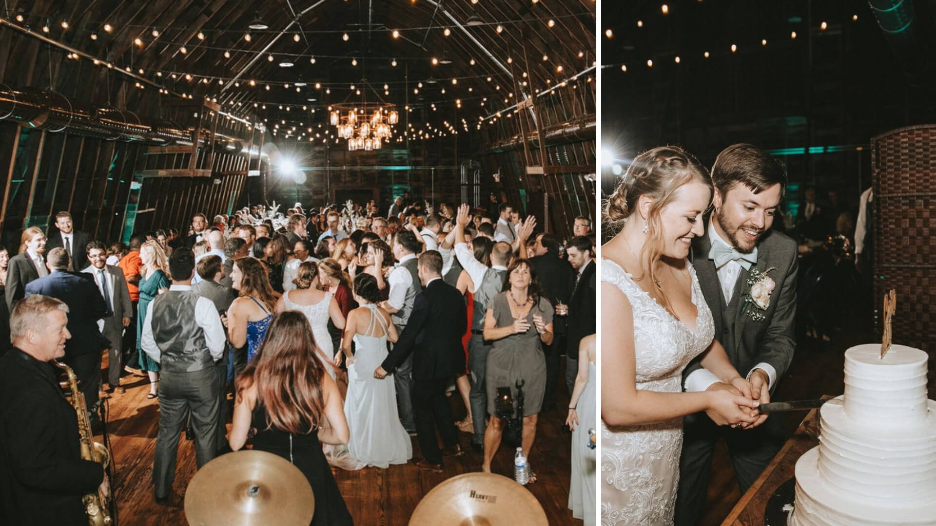 A crowded wedding reception with guests dancing, and a bride and groom cutting a tiered cake under string lights in a rustic venue.
