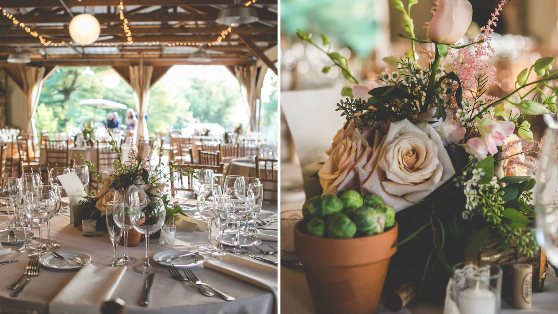 A decorated wedding reception hall with elegantly set tables. Close-up of a floral centerpiece featuring roses and greenery in a terracotta pot, alongside glassware and cutlery.
