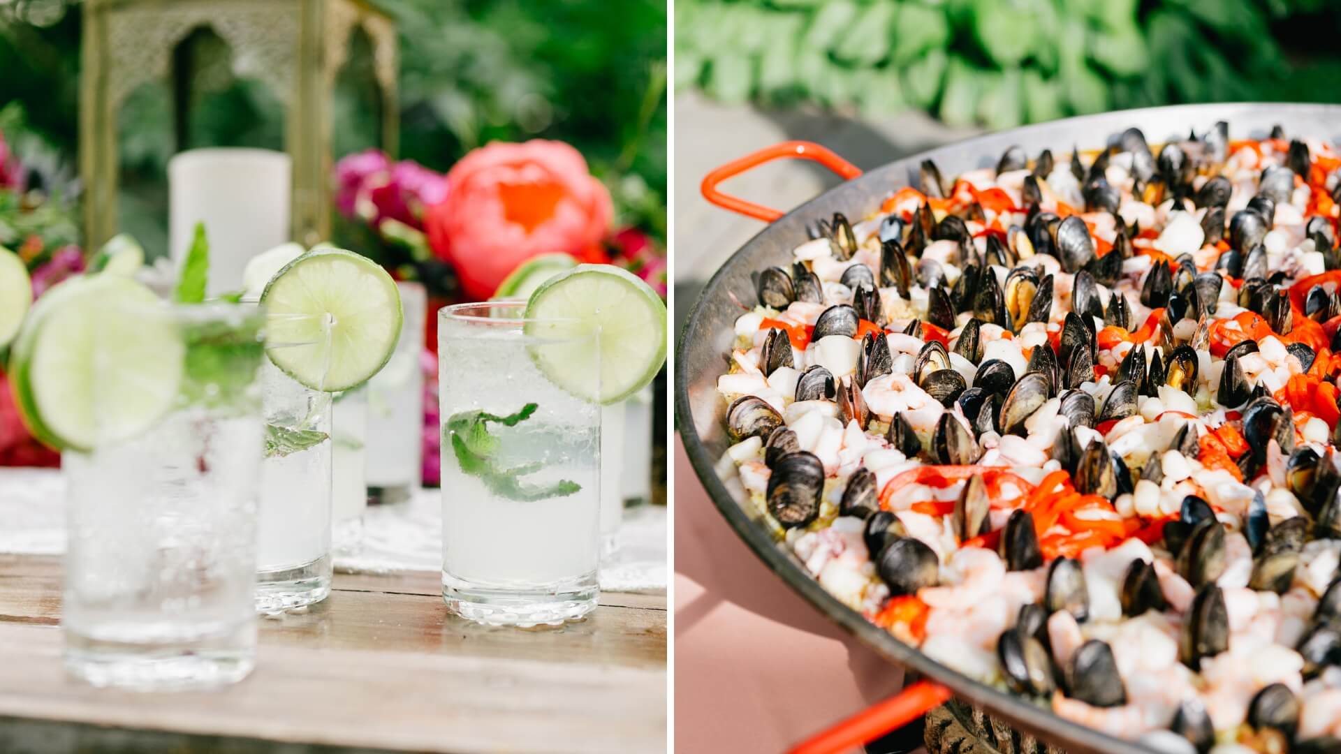 Glasses of lime and mint cocktails on a wooden table next to a large pan filled with seafood paella, garnished with red peppers.