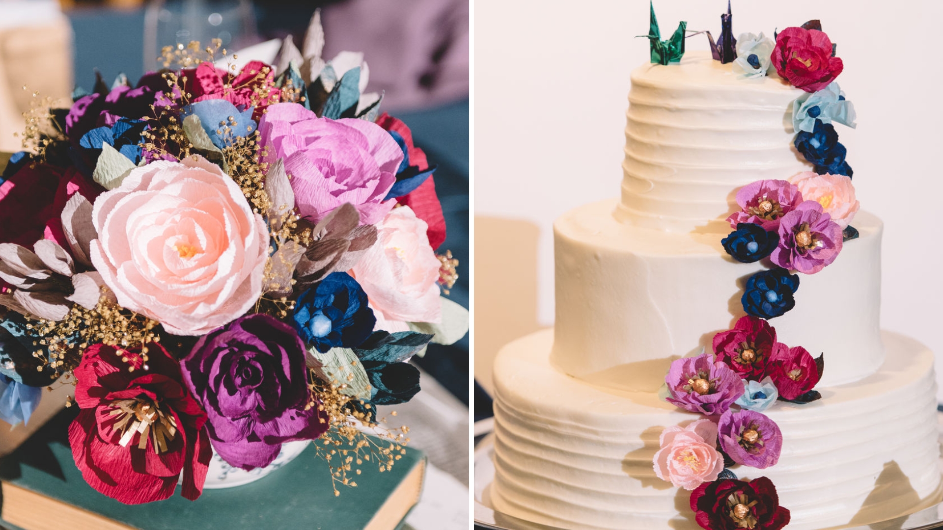 A vibrant bouquet of paper flowers next to a three-tiered white cake adorned with matching colorful paper flowers cascading down.