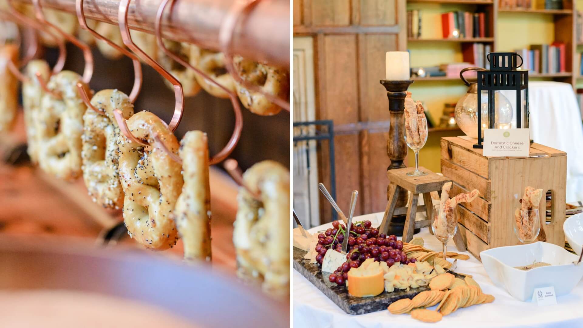 Pretzels hanging on copper rods; cheese, grapes, and crackers on a table with decorative elements including a lantern and candle.